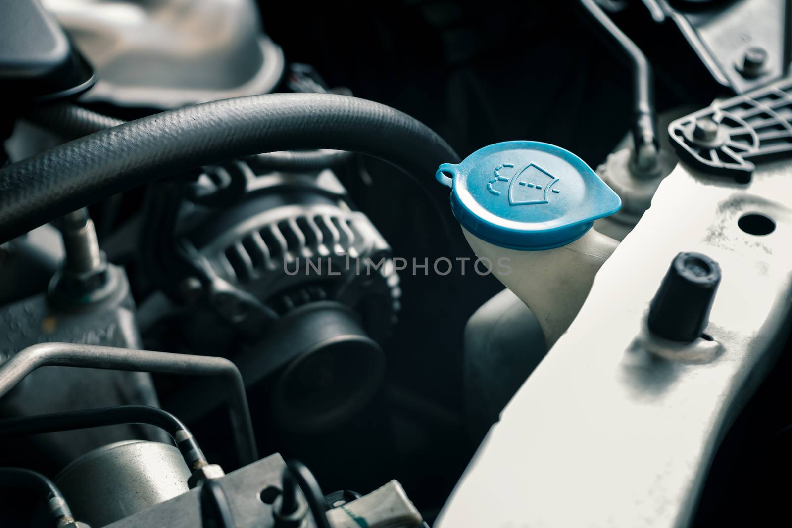 details of modern car engine, windshield washer tank sign on cap, shallow depth of field