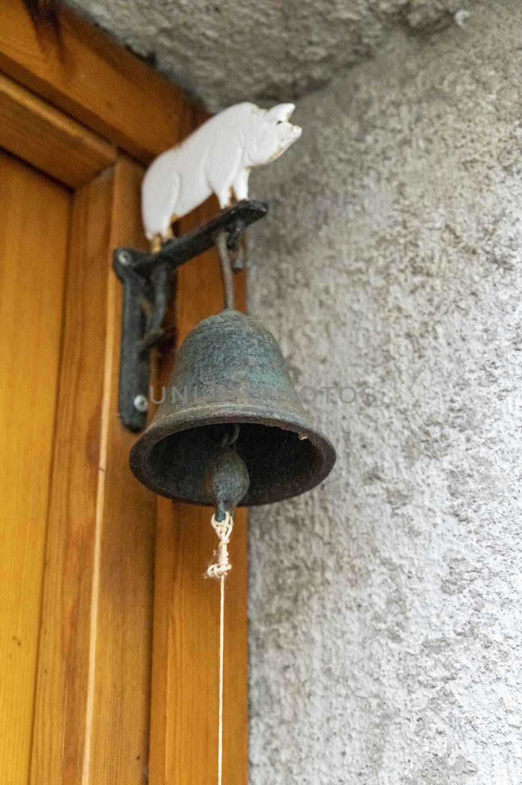 vintage bell hanging on a door to ring