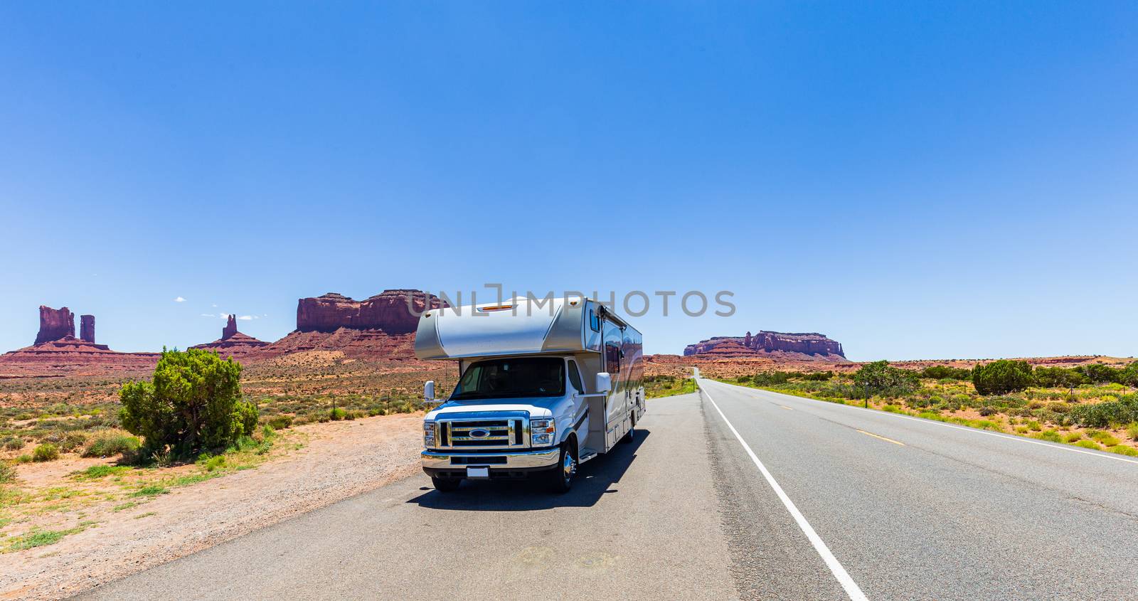 Camper Van on scenic drive in Monument Valley Navajo Park, Utah, USA
