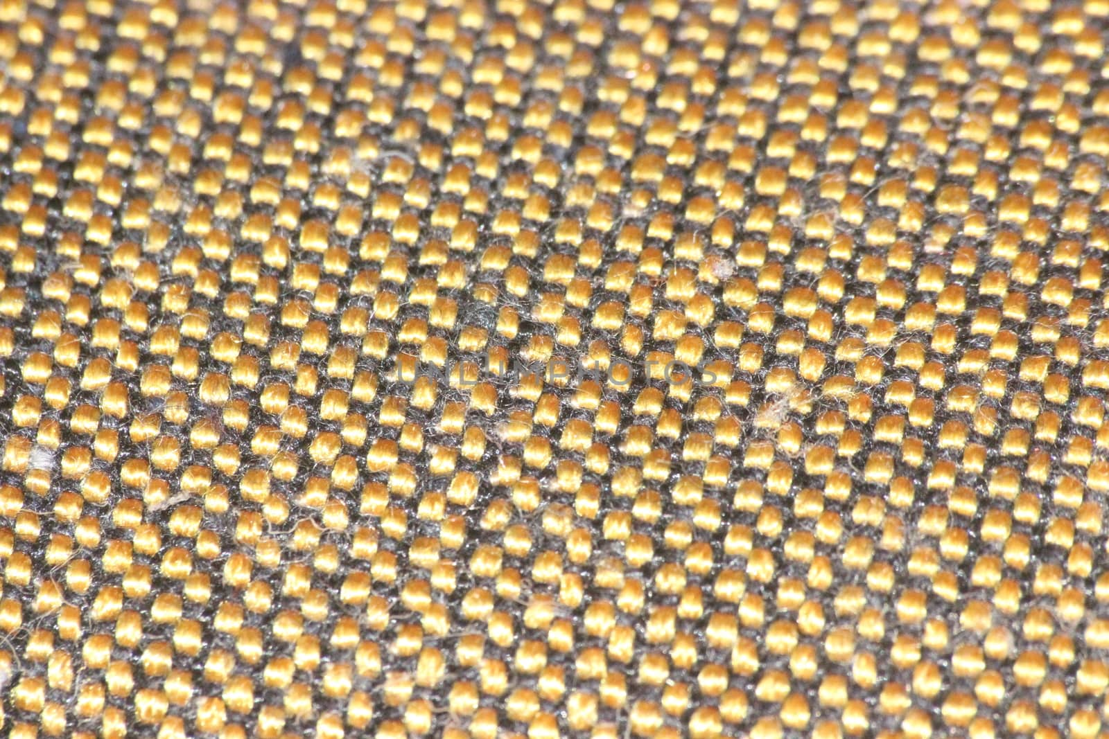 macro photo as background close up of golden color cloth fibers knitted and woven