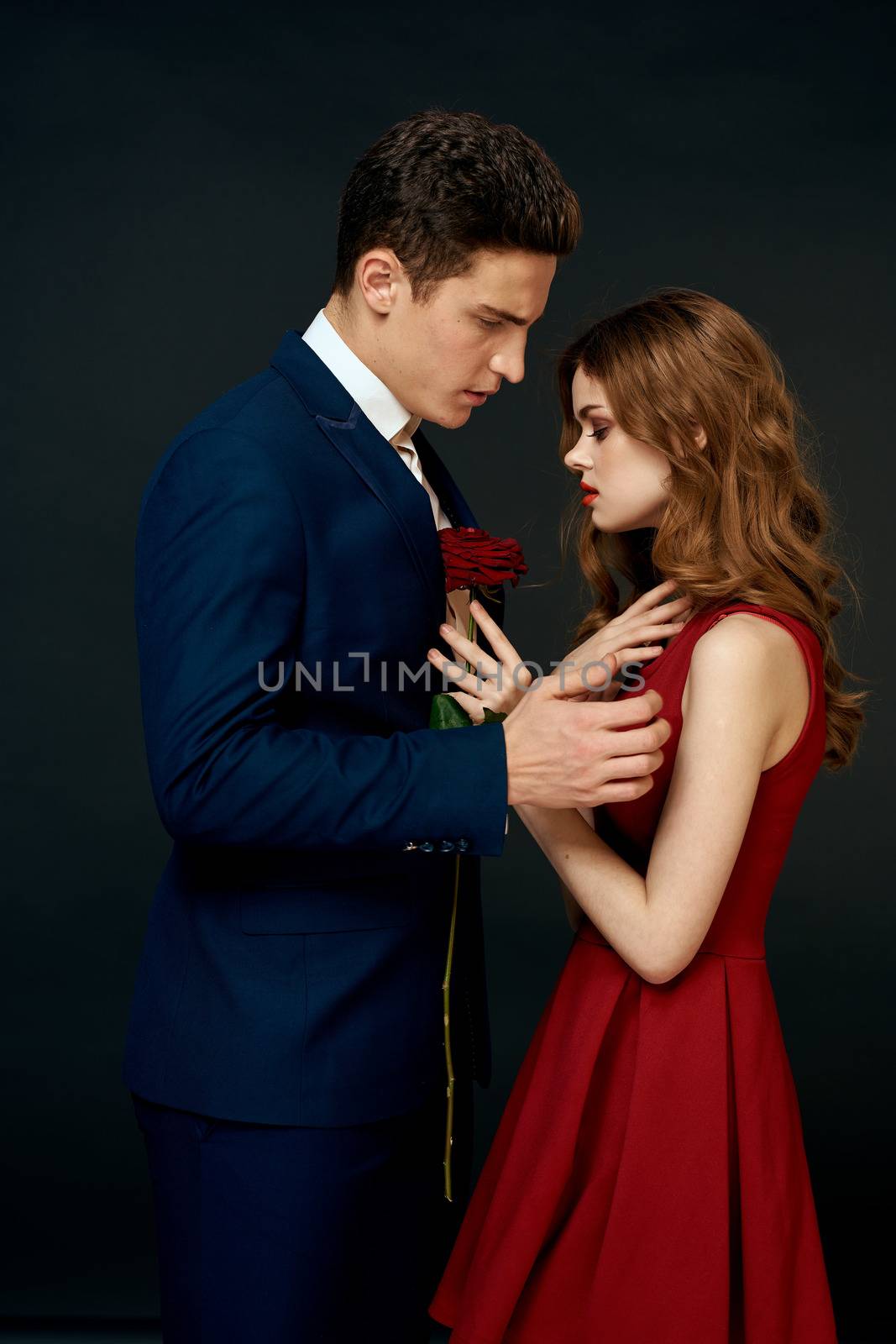 luxury couple hug romance relationship rose over dark isolated background by SHOTPRIME