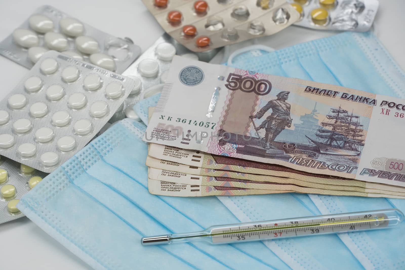 A thermometer, a pill, a medical mask and money in Rubles are on by YevgeniySam
