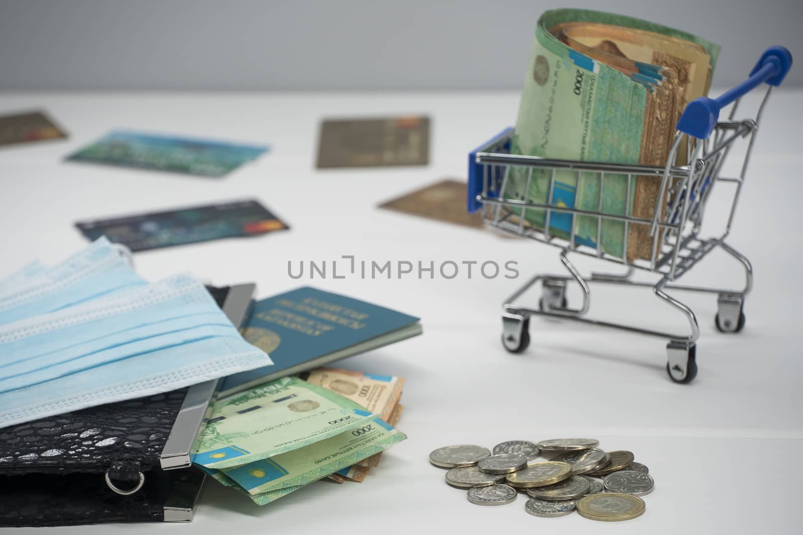 Quarantine and border closure in Kazakhstan for coronavirus. On the table are money in tenge with medical face masks, a globe, a card and a passport. Closing borders and leaving for Kazakhstan.