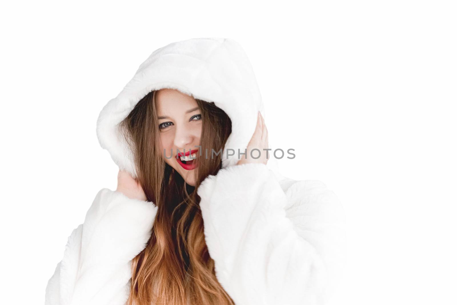 Young woman in fluffy fur coat with hood wrap, warm winter clothing for fashion and Christmas holidays design