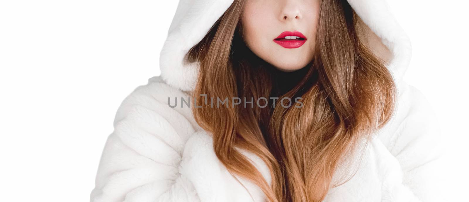 Young woman in fluffy fur coat with hood wrap, warm winter clothing for fashion and Christmas holidays design