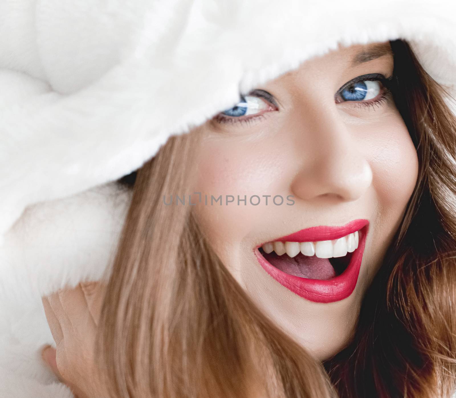 Young woman in fluffy fur coat with hood wrap, warm winter cloth by Anneleven