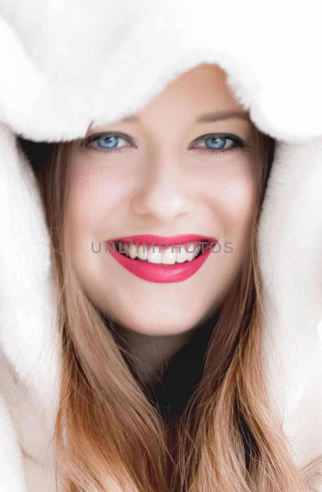 Young woman in fluffy fur coat with hood wrap, warm winter clothing for fashion and Christmas holidays design