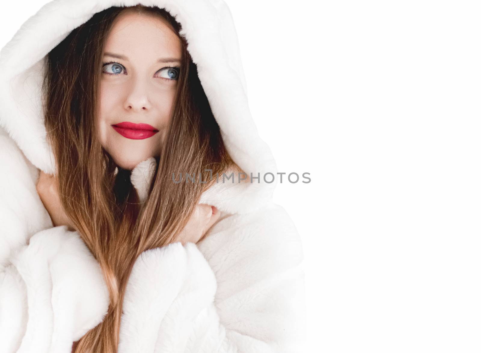 Young woman in fluffy fur coat with hood wrap, warm winter clothing for fashion and Christmas holidays design