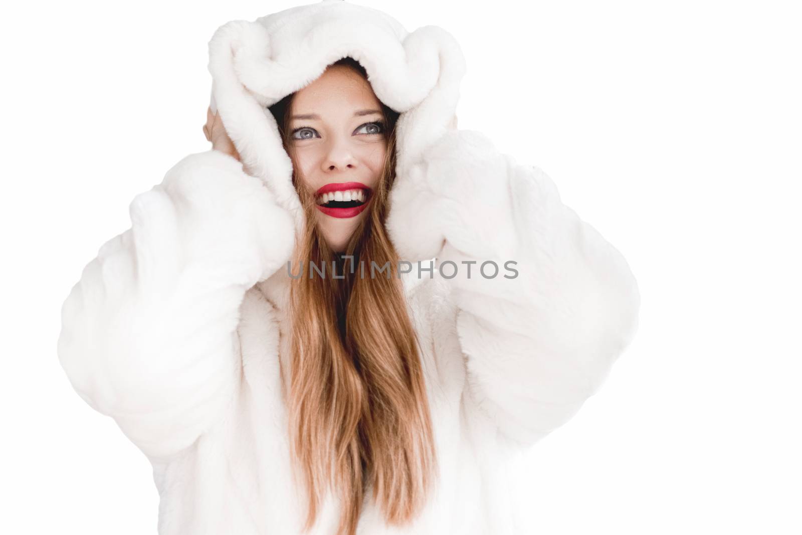 Young woman in fluffy fur coat with hood wrap, warm winter clothing for fashion and Christmas holidays design