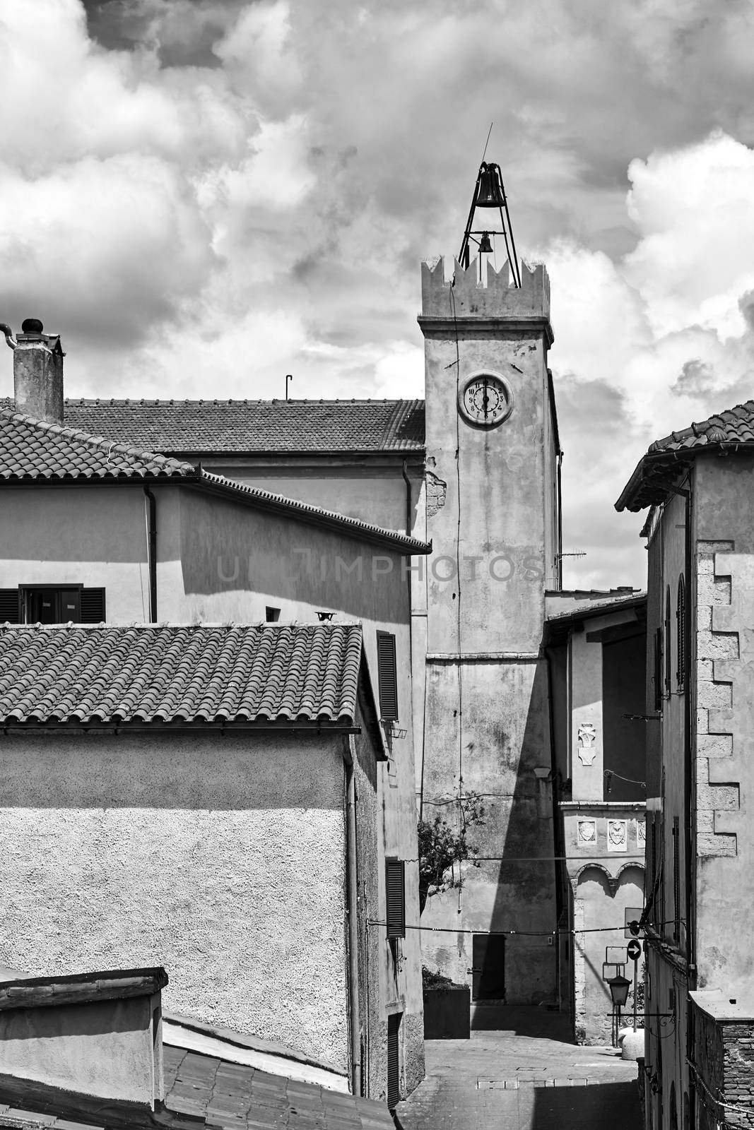 Historic clock tower in the city of Magliano in Toscana, Italy, monochrome