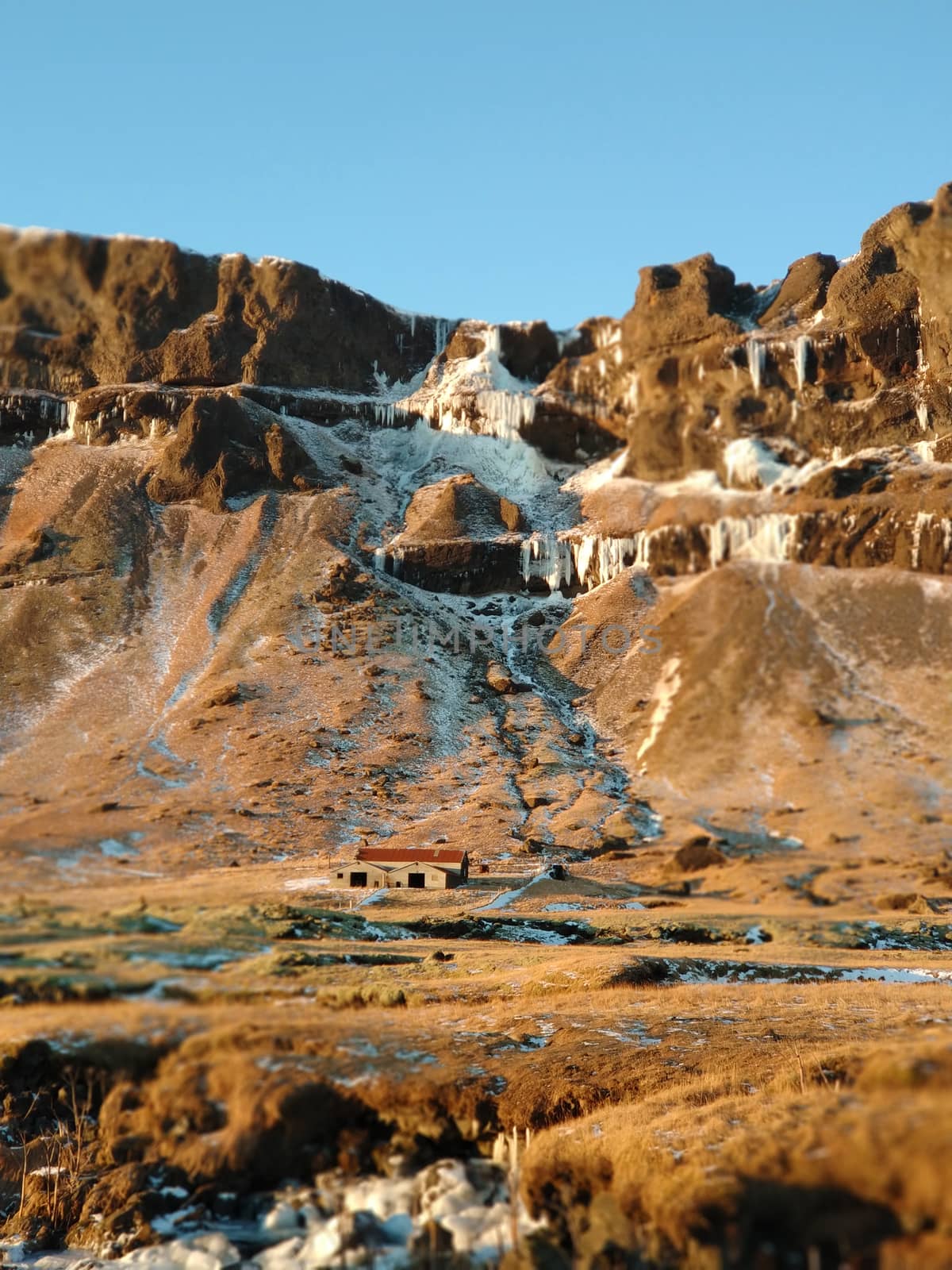 A lonely house at the foot of the mountains in Iceland. Incredible landscapes of nature. Life for a social phobia.