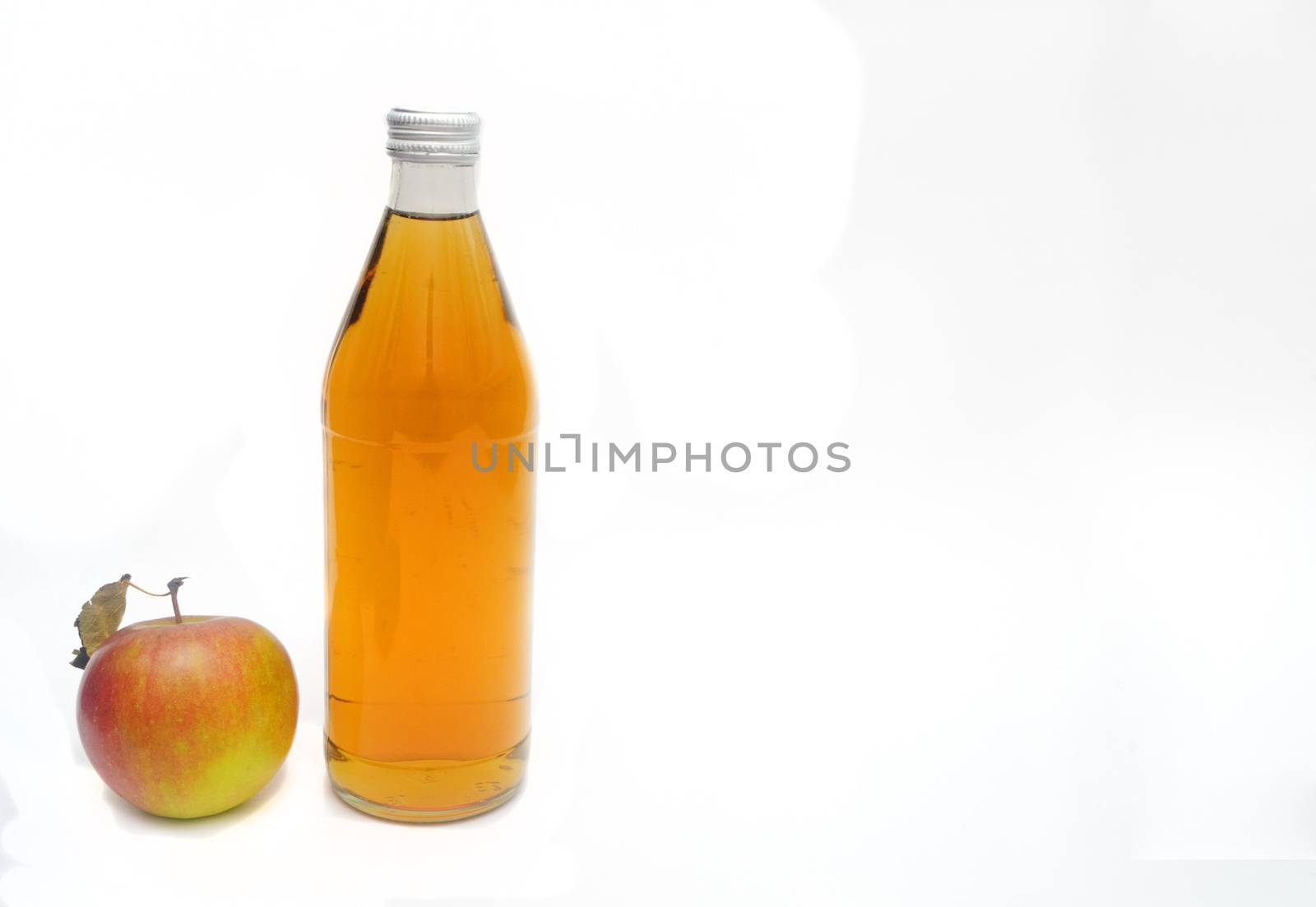 One whole apple with leaf and a bottle of apple cider vinegar ion white background, copyspace.. by andre_dechapelle