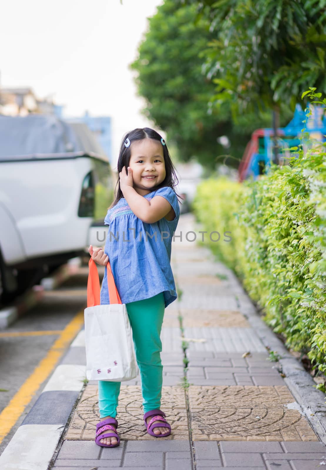 little girl carrying cloth bag to prepare to shopping, protect t by domonite