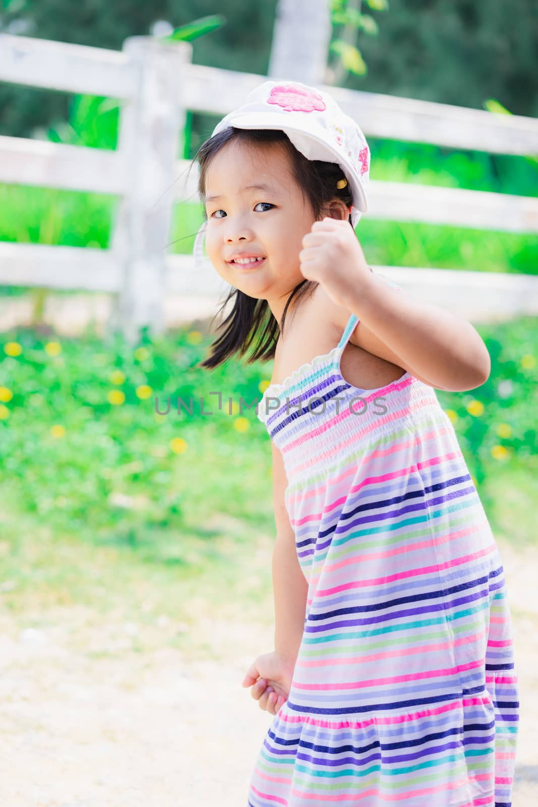 portrait of cute asian little girl in the park by domonite
