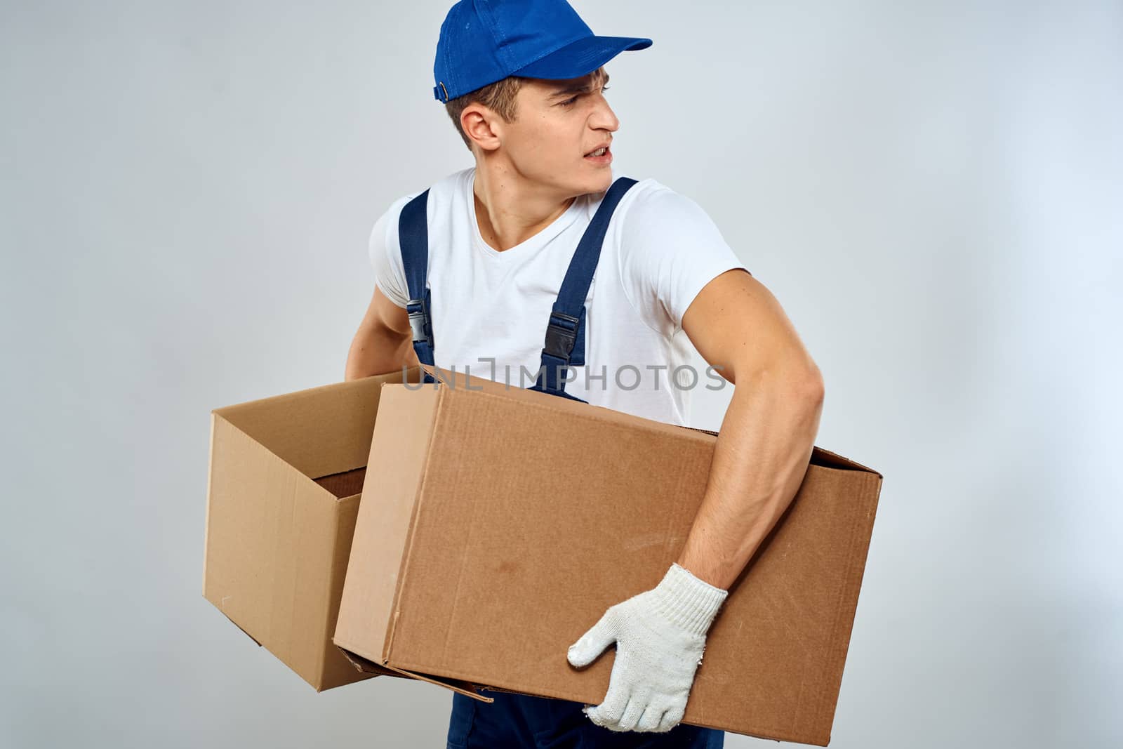 Man worker with box in hands delivery loading service packing service. High quality photo