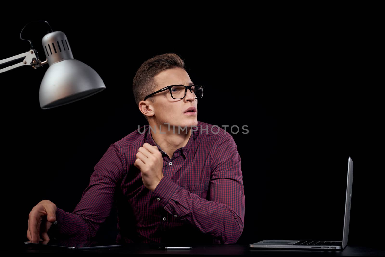 Male manager indoors dark background communication red shirt model glasses new technologies business finance by SHOTPRIME