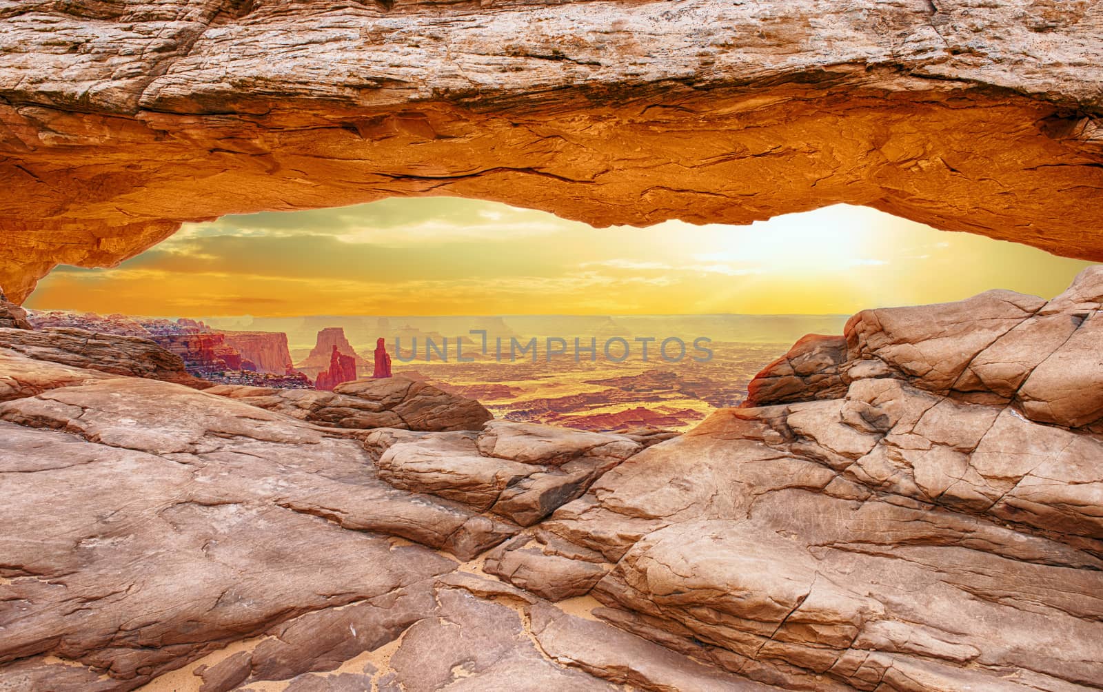 Vivid sunrise through Mesa Arch in Canyon Lands  by fyletto
