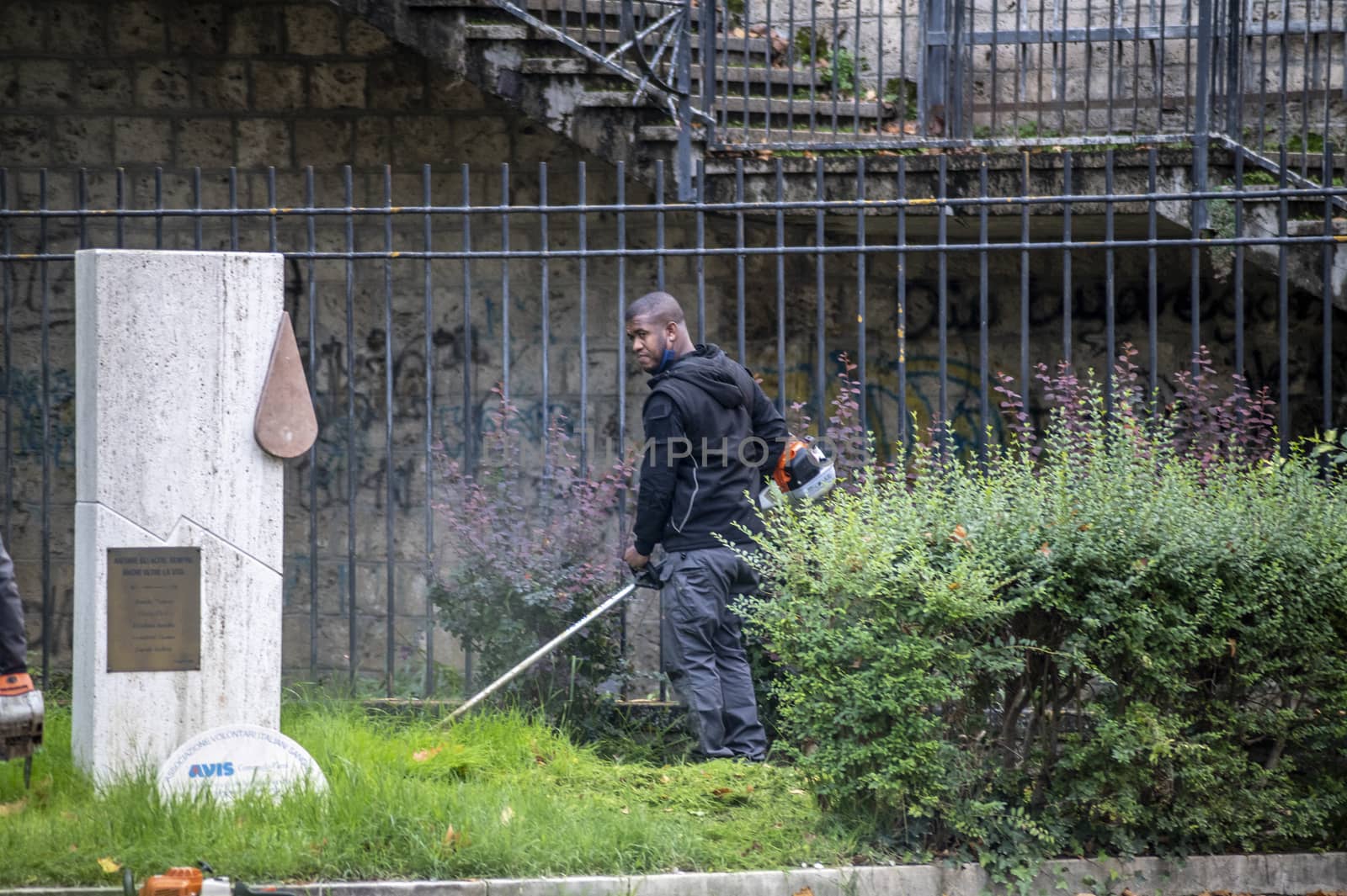 terni,italy actober 17 2020:black gardener who works for the municipality of terni