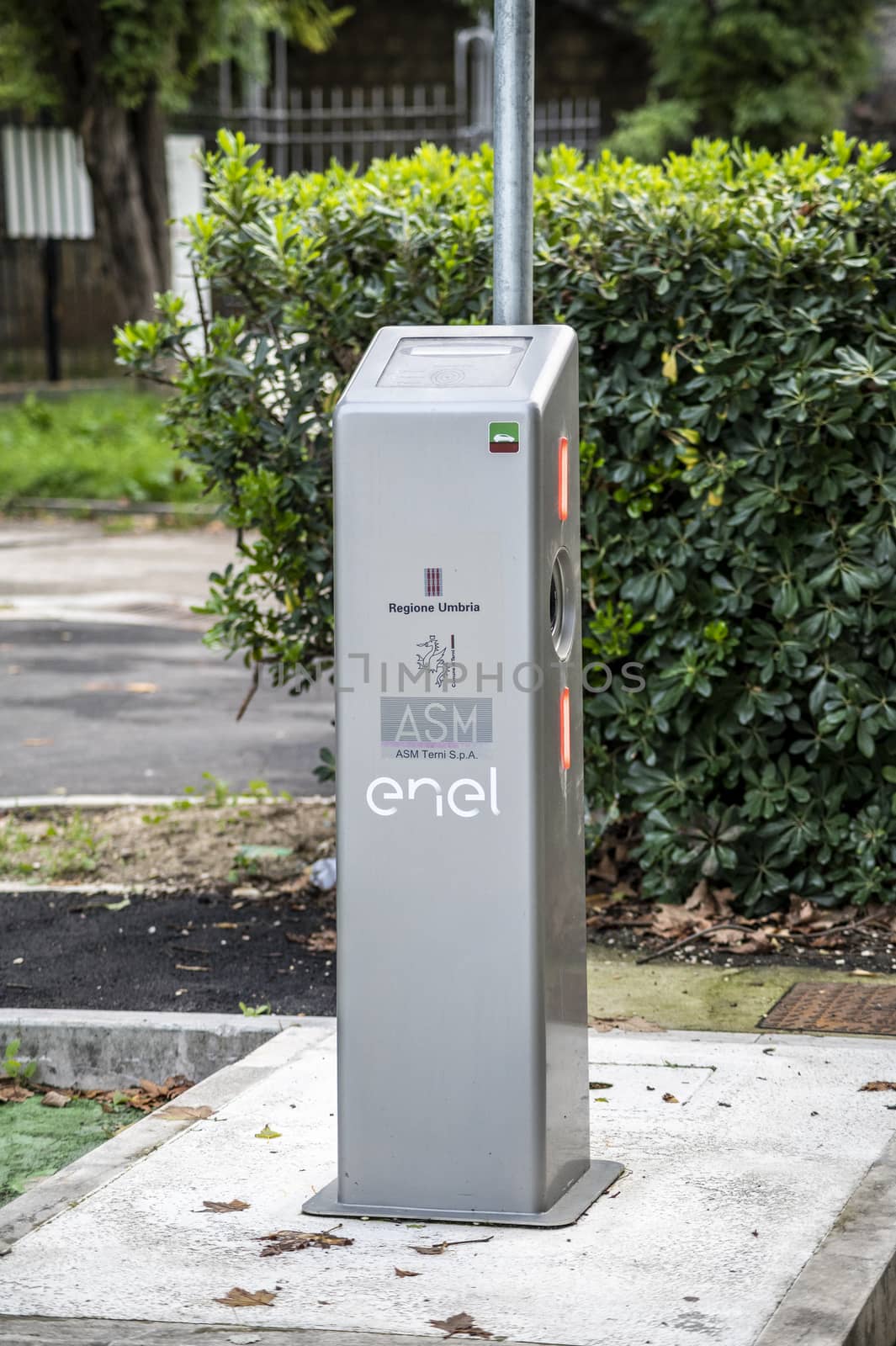 column for charging electric car located in the city by carfedeph