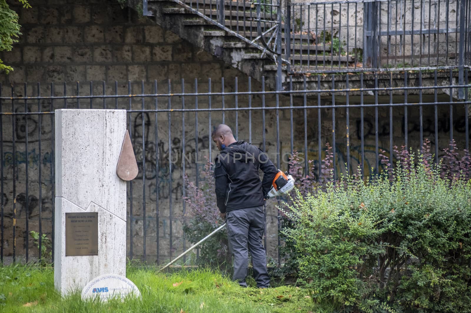 terni,italy actober 17 2020:black gardener who works for the municipality of terni