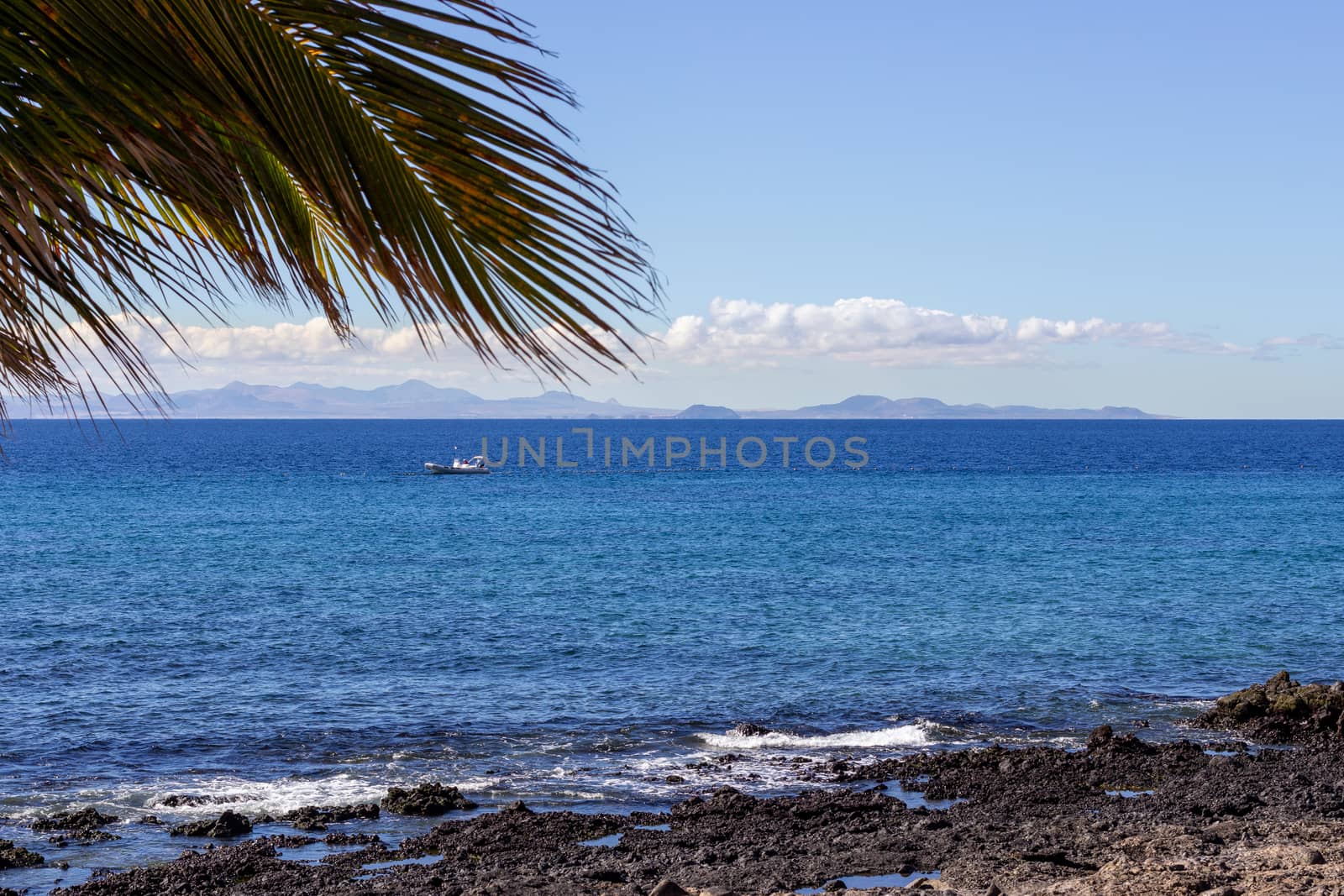 Rocky coast of Puerto del Carmen at Canary island Lanzarote with by reinerc