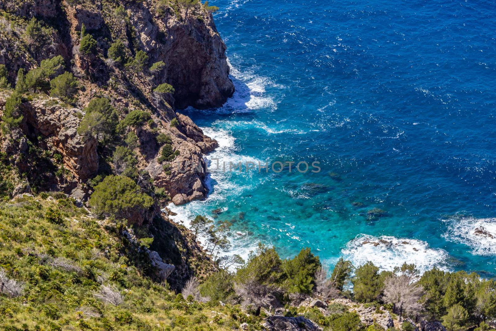 Scenic view from viewpoint Mirador Ricardo Roco on a bay at the north coast of Mallorca with rocky coastline and clear turquoise water
 