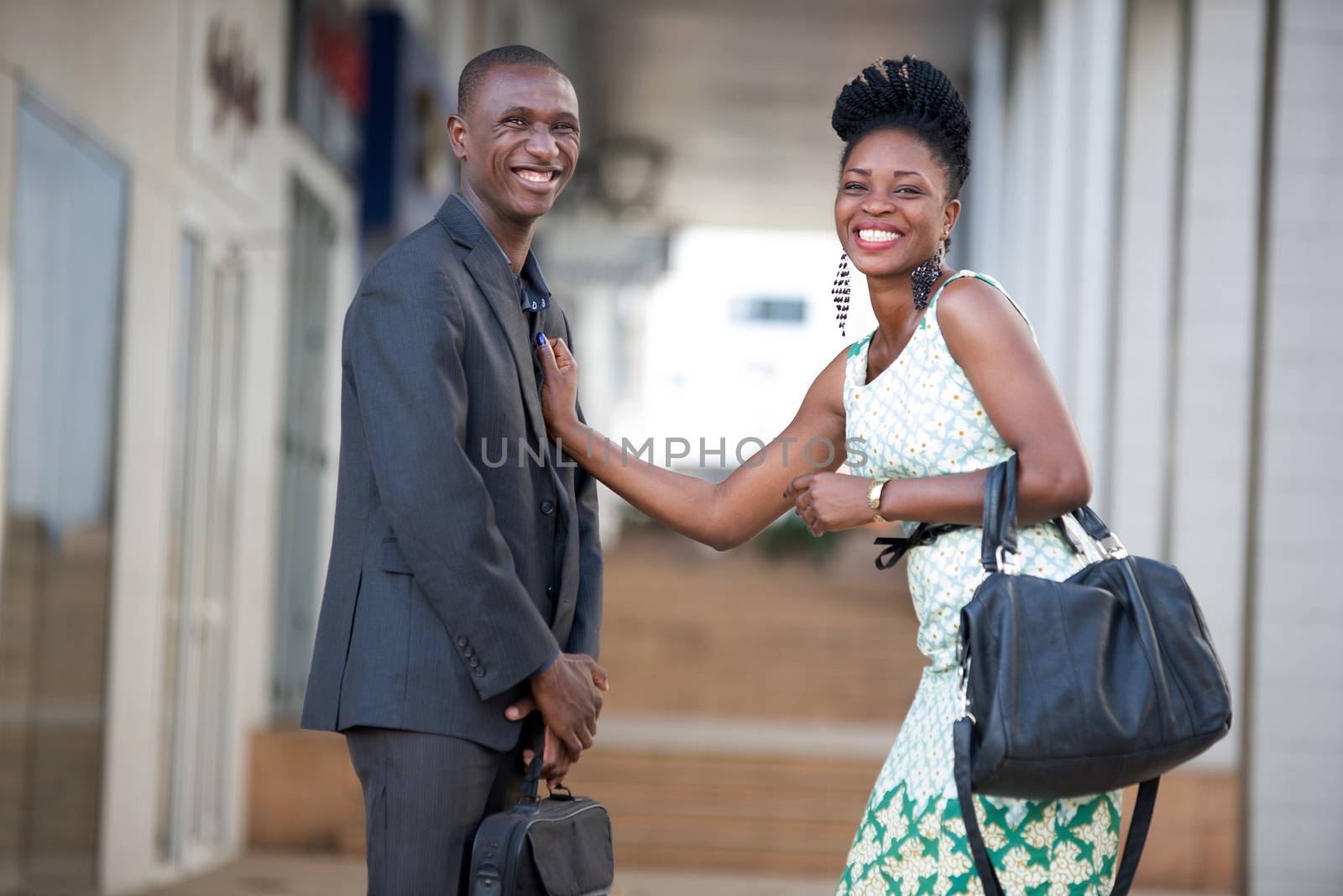 Happy business people standing in a passage discussing and laughing