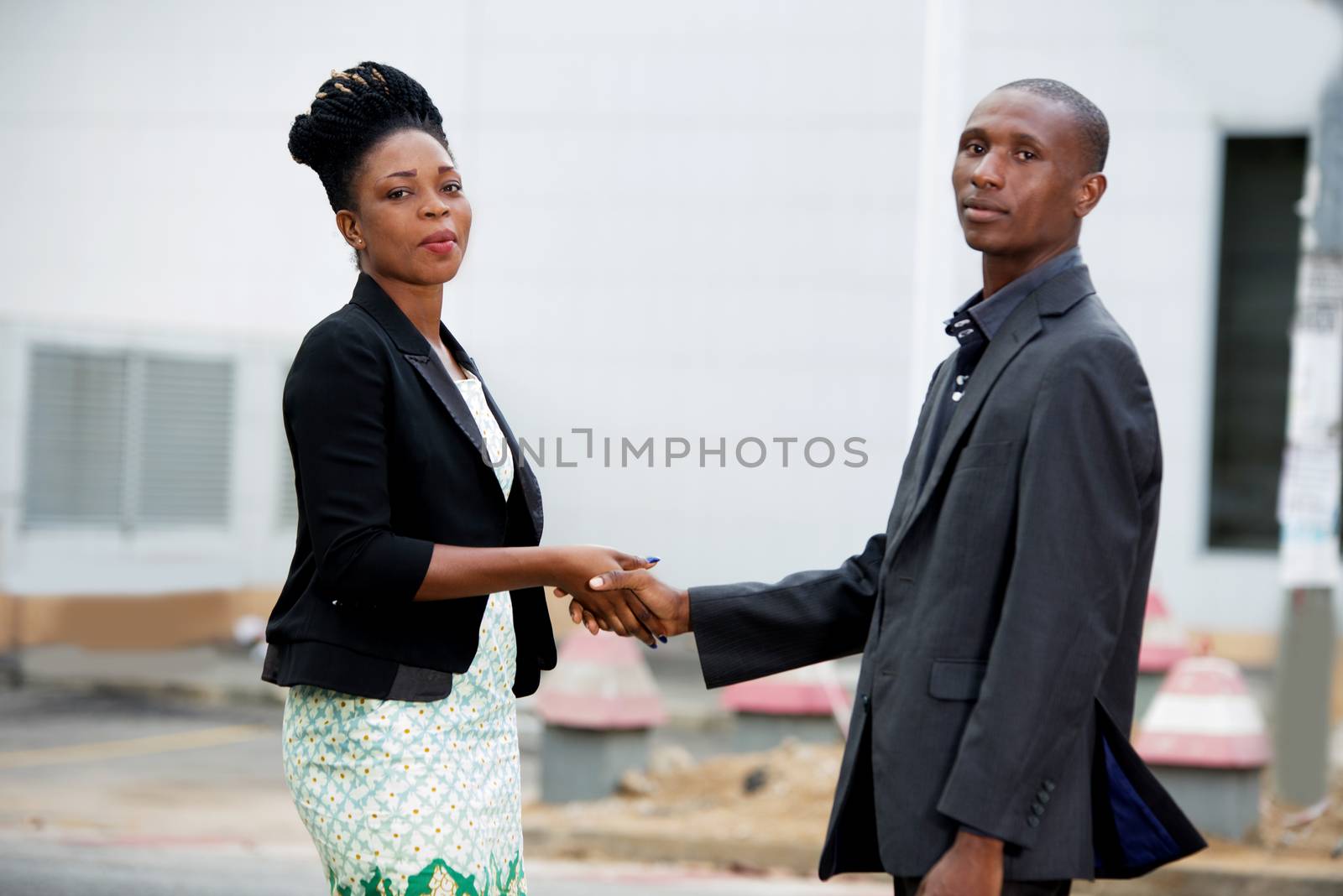team of man and businesswoman shaking hands in the city