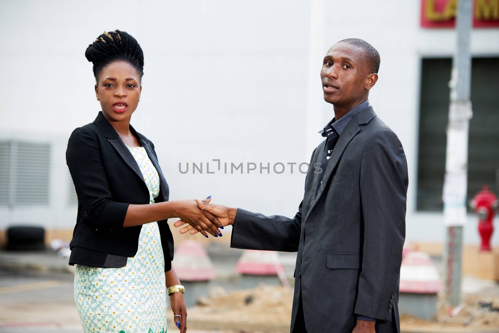 Handshake between a man and a businesswoman meeting in the street