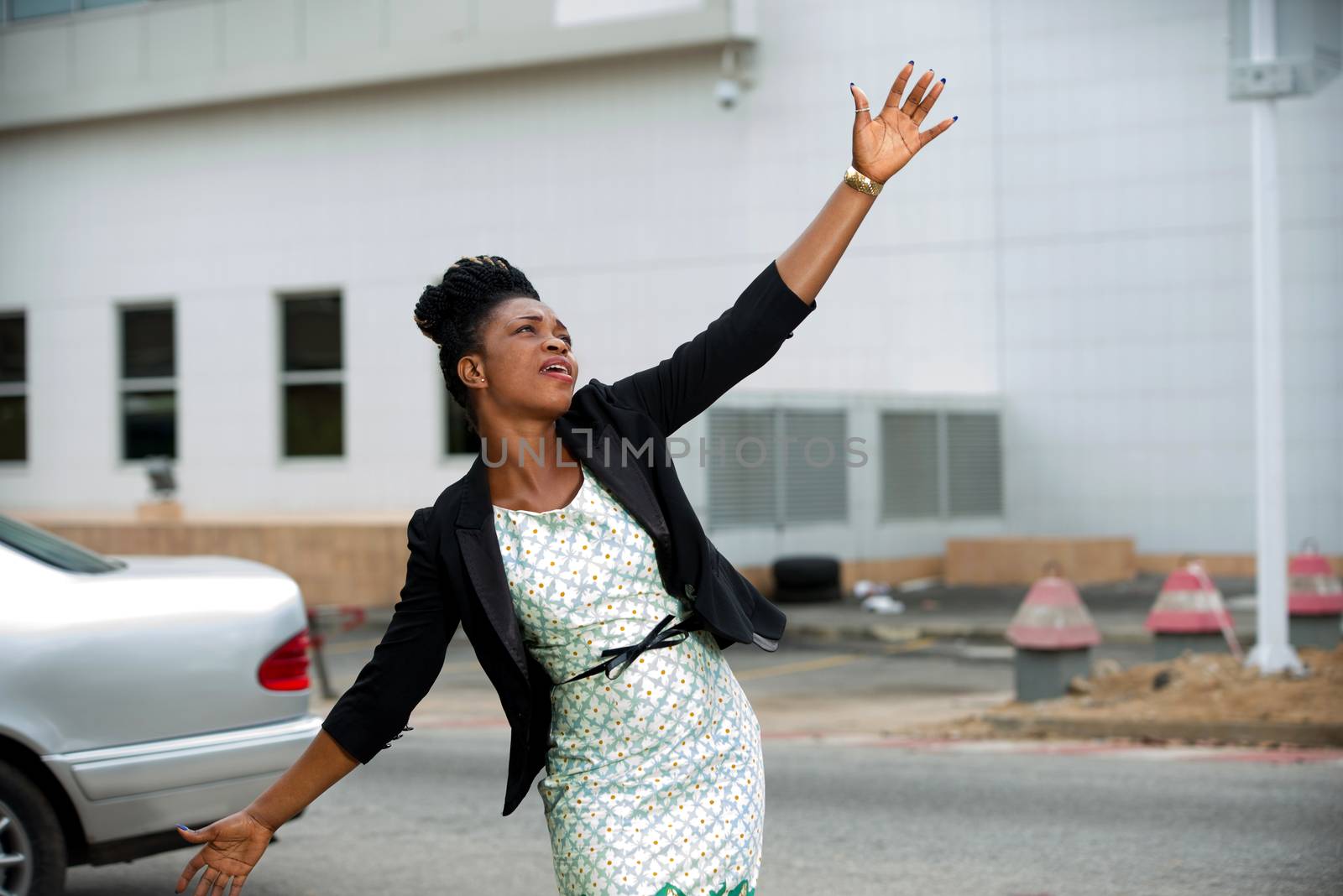 young businesswoman shows her success after work in shout of joy on the street