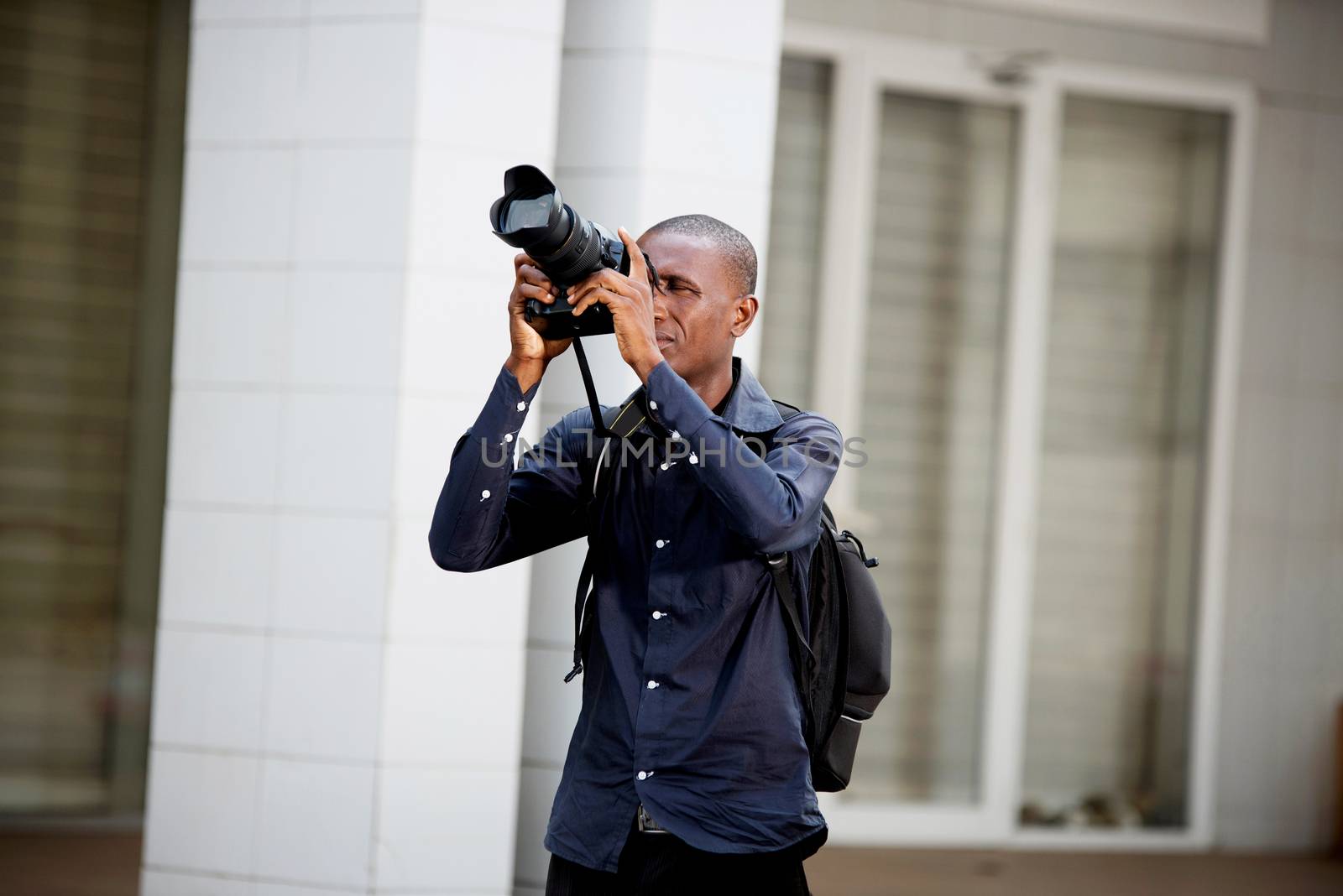 young tourist taking pictures in the city