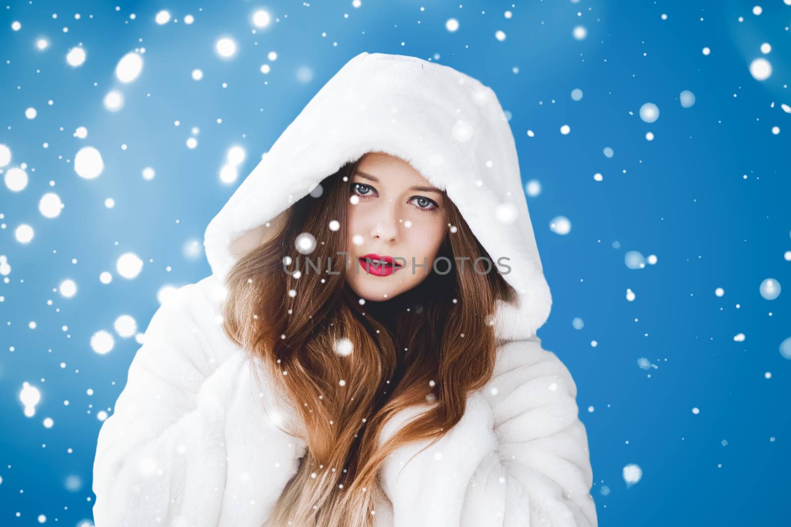 Happy Christmas and winter holiday portrait of young woman in wh by Anneleven