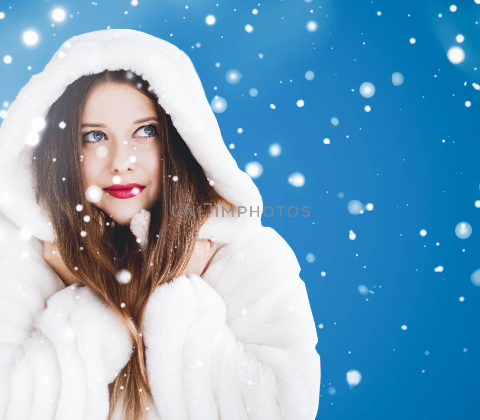 Happy Christmas and winter holiday portrait of young woman in wh by Anneleven