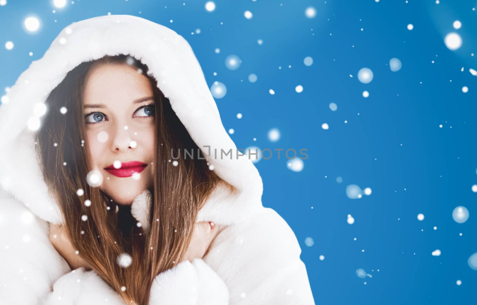 Happy Christmas and winter holiday portrait of young woman in wh by Anneleven