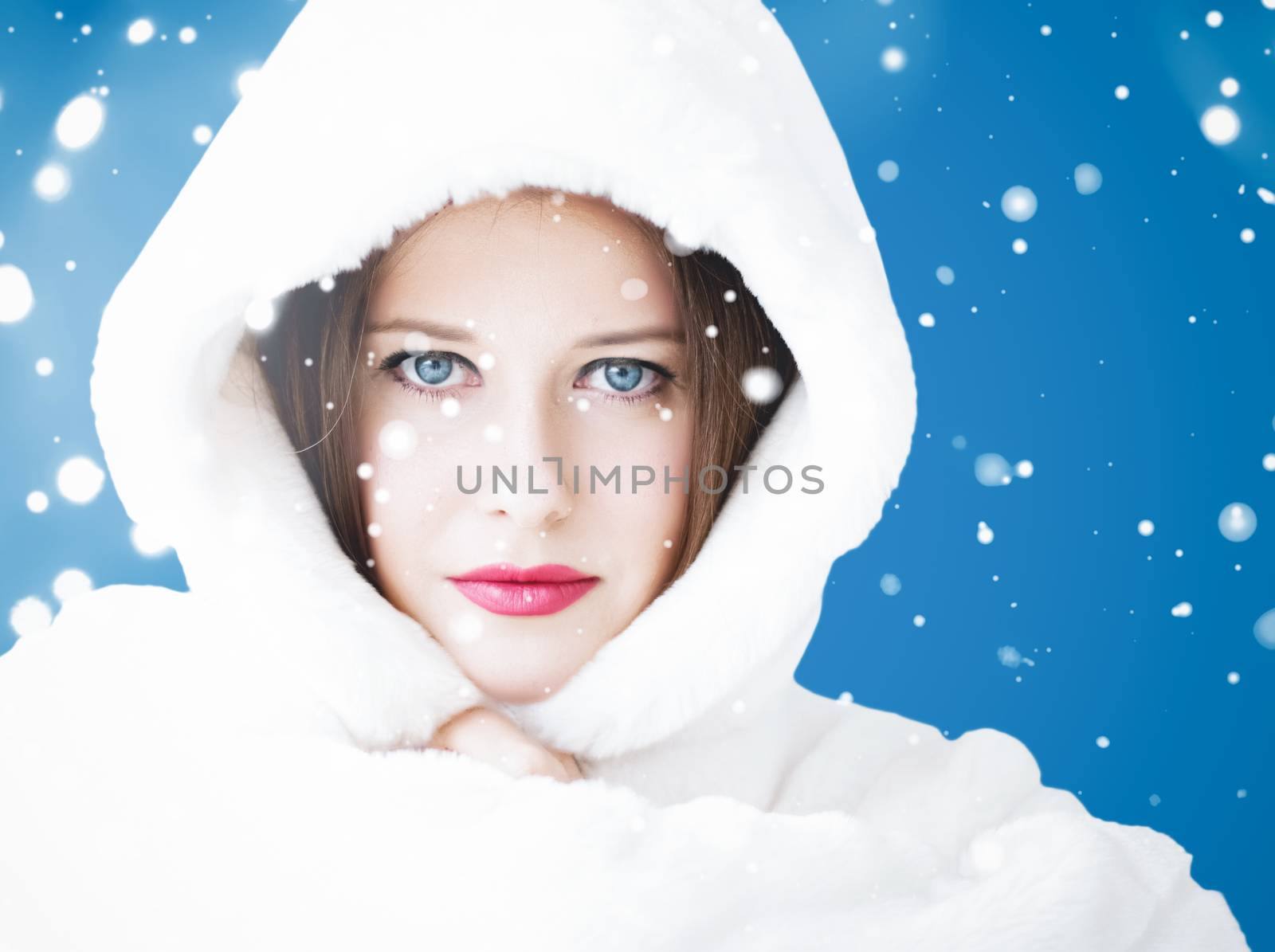 Happy Christmas and winter holiday portrait of young woman in wh by Anneleven