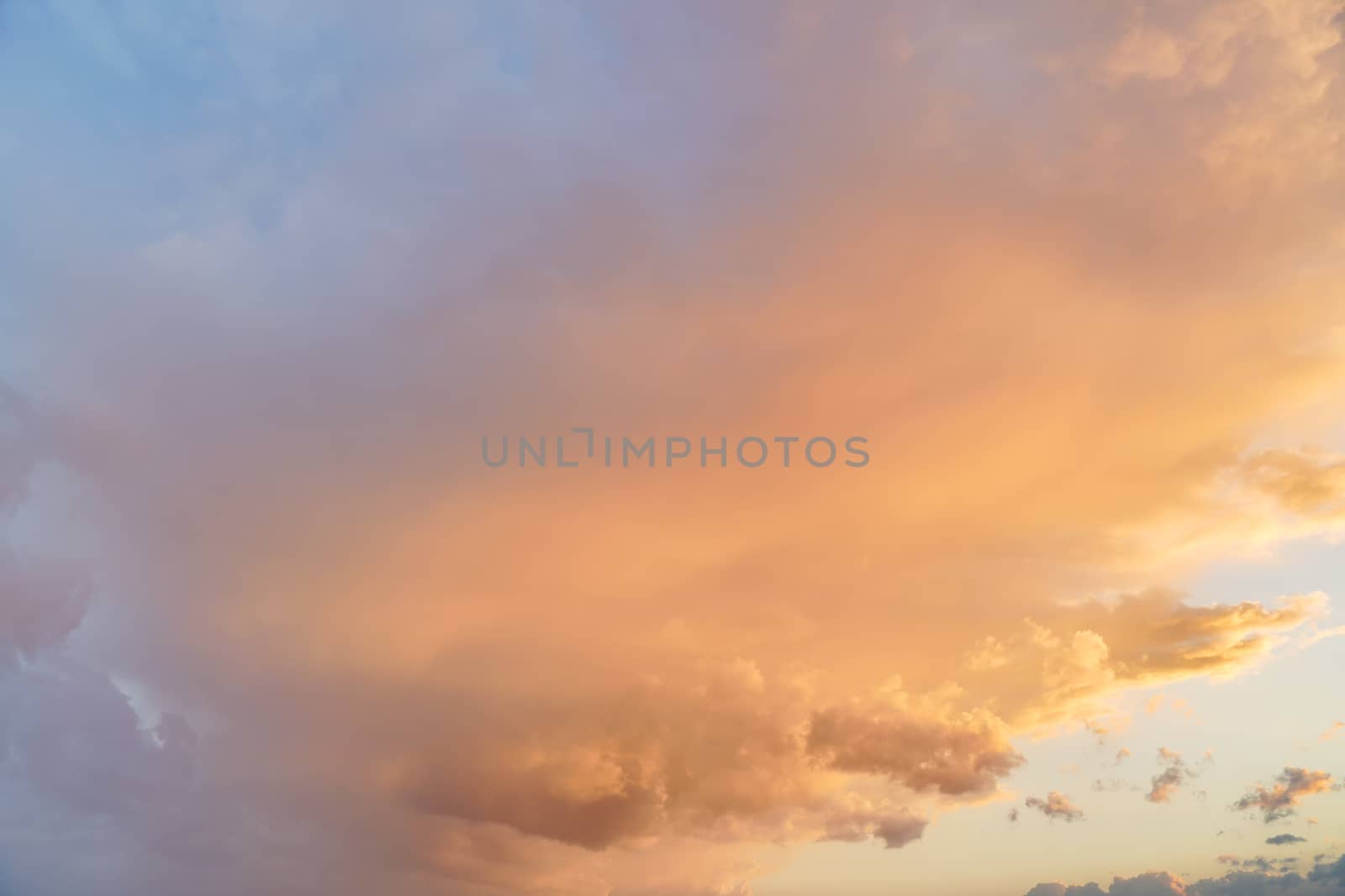 Orange pink evening sky just after sunset - afternoon clouds background.