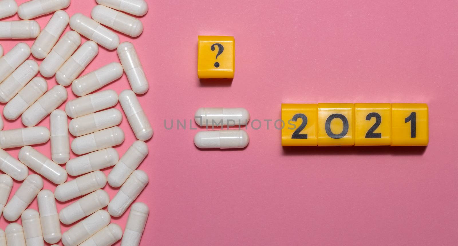 Top view of white pills equal 2021 and question mark sign above the equal sign on pink background. Healthcare concept. New normal and reality concept. Banner size.