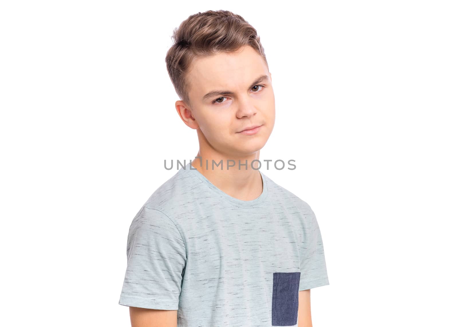 Handsome teen boy with serious expression on face, isolated on white background