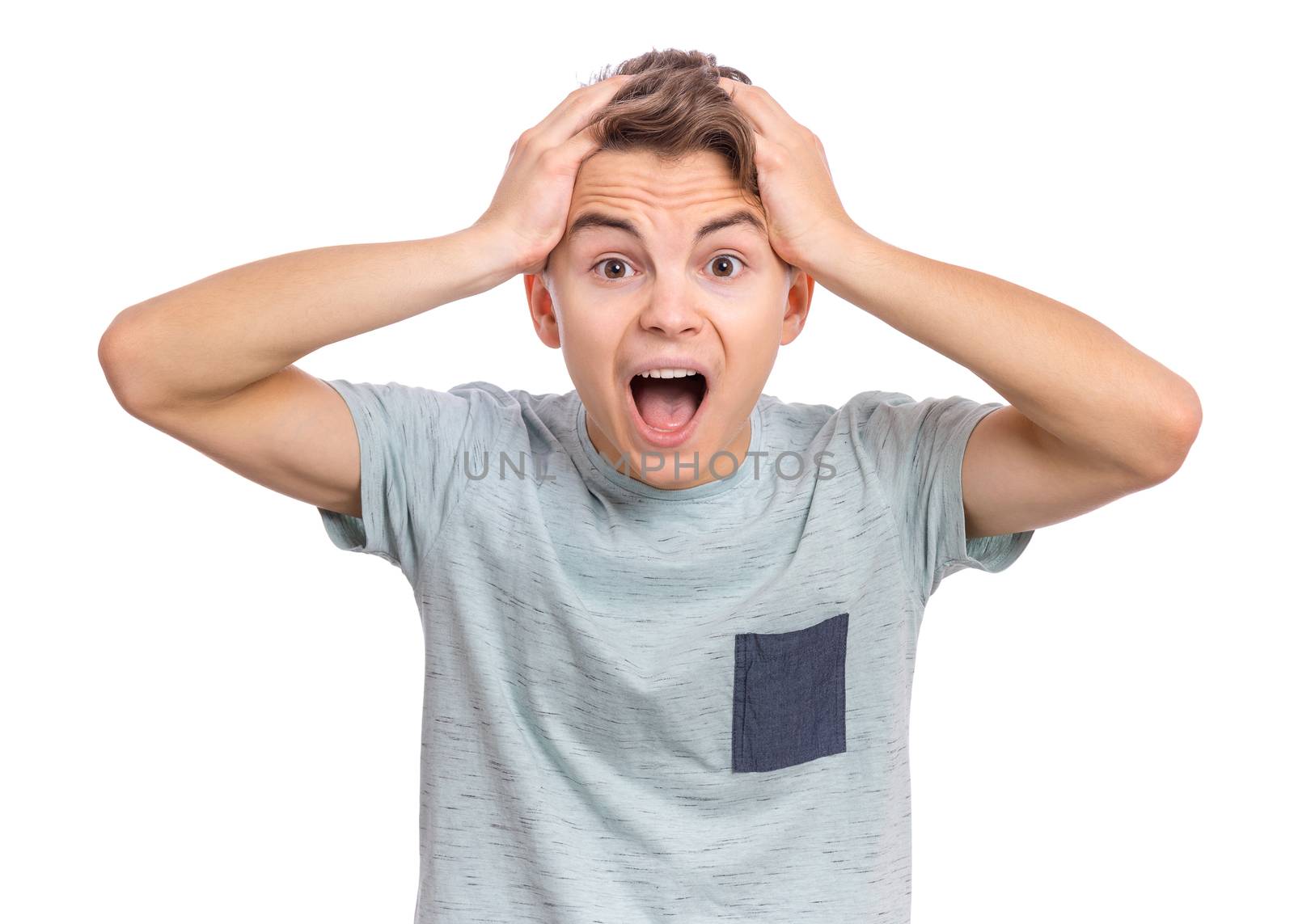 Emotional portrait of scared boy teenager, isolated on white background