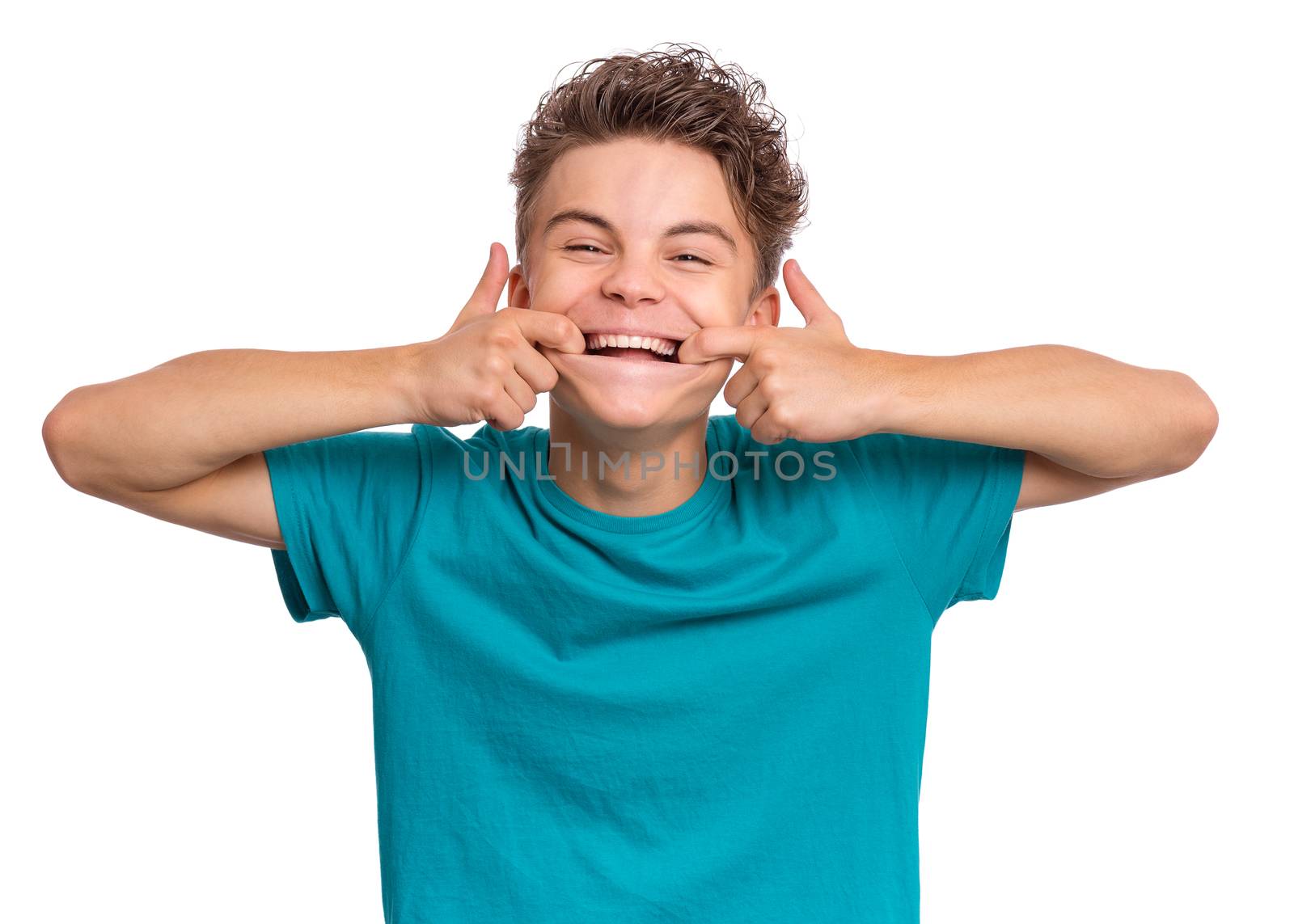 Handsome teen boy showing his to teeth, isolated on white background