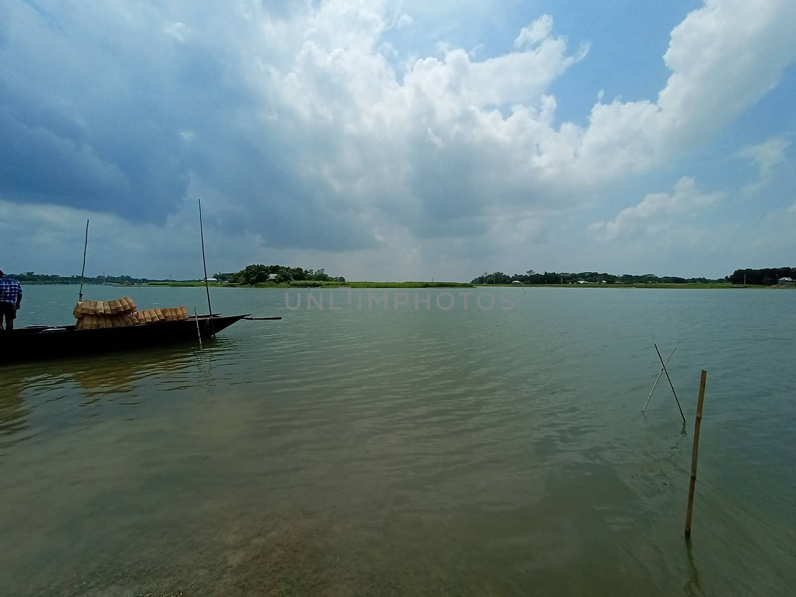 black colored wooden boat on river with sky