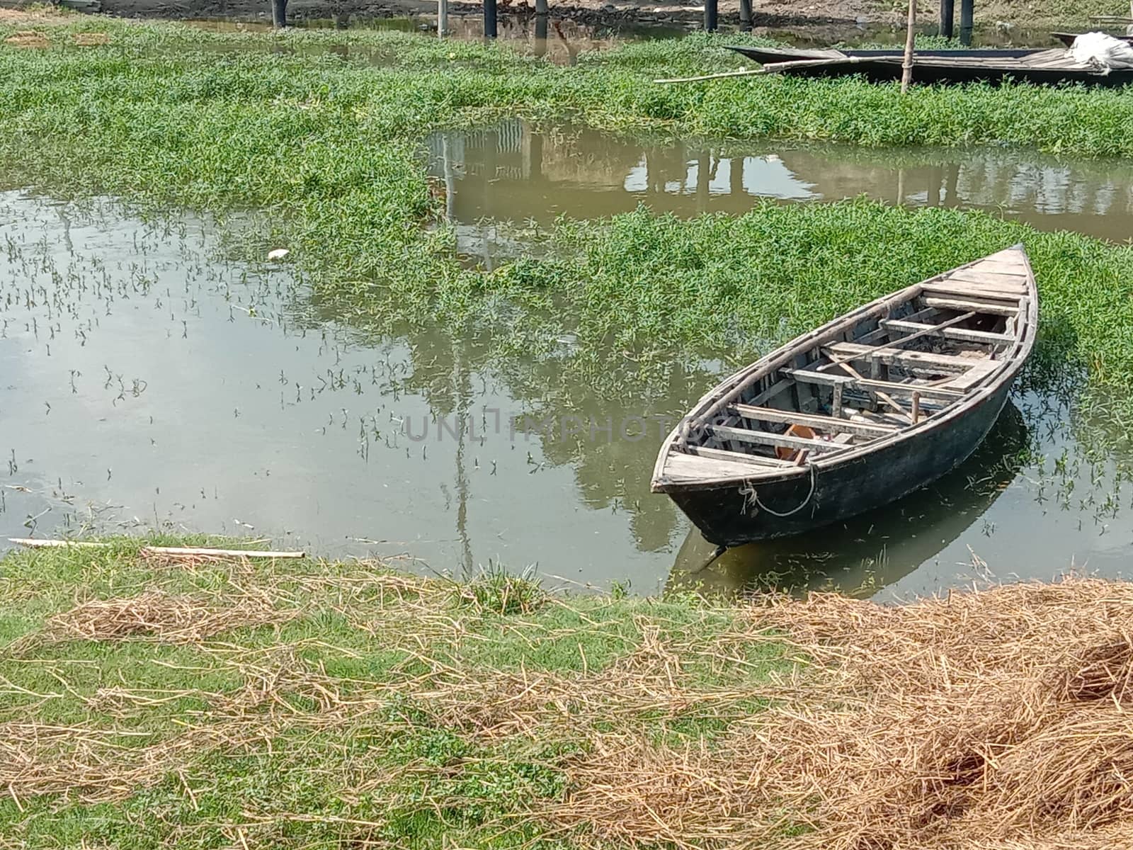black colored wooden boat on lake
