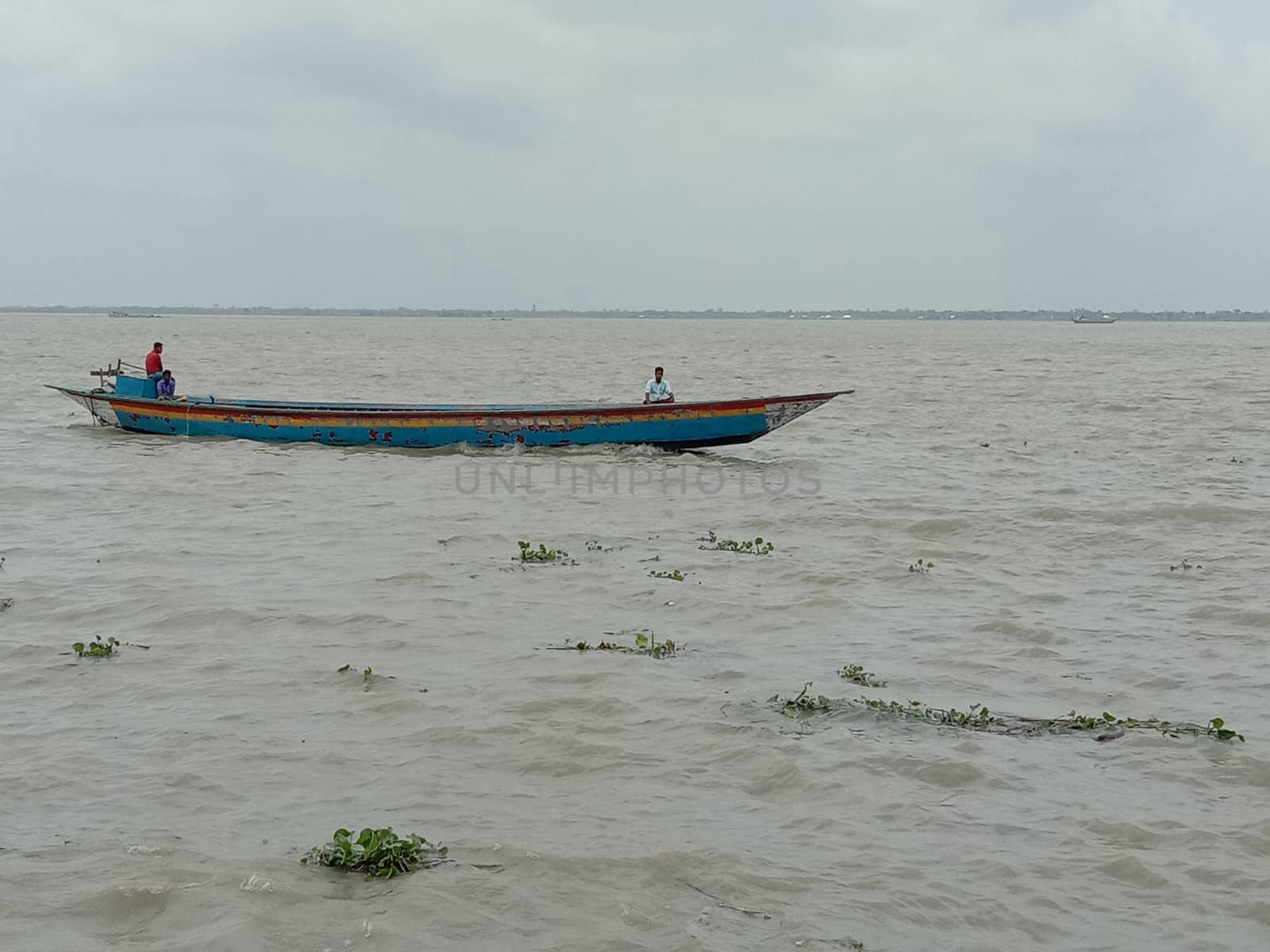 wooden fishing boat on river with sky