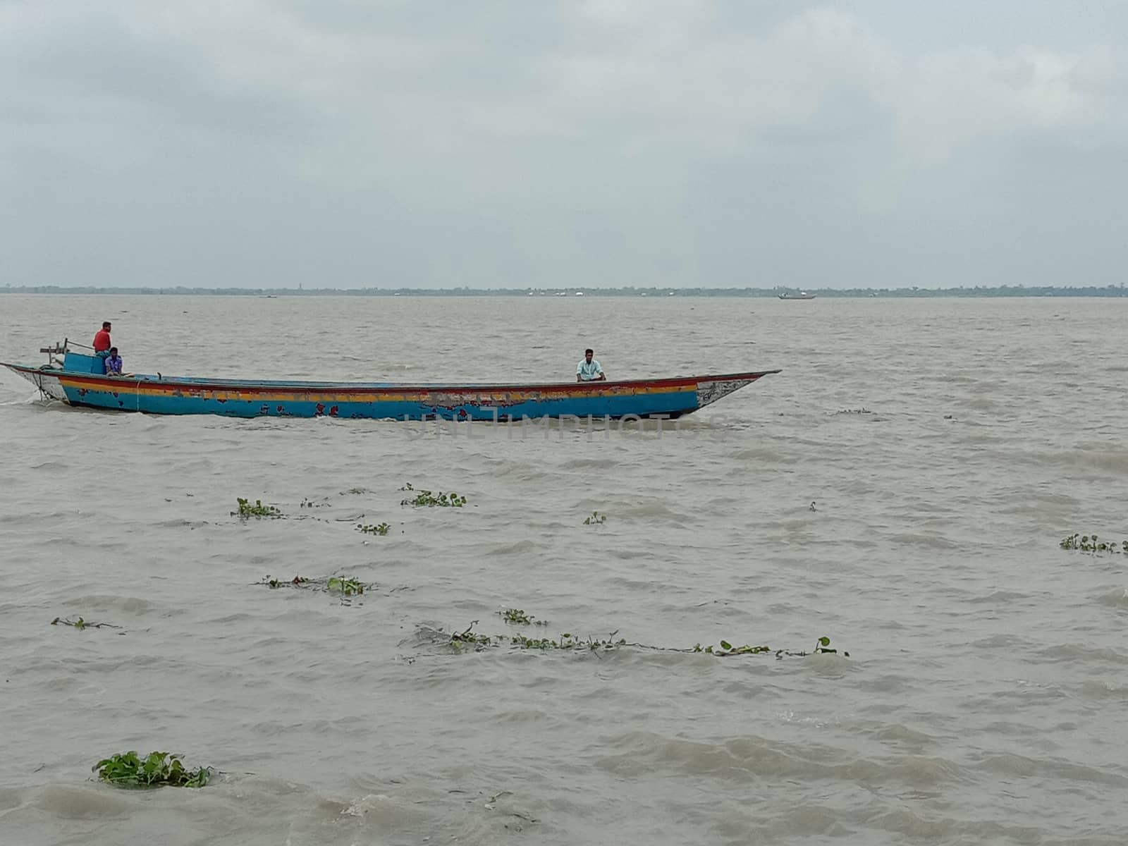 wooden fishing boat on river with sky