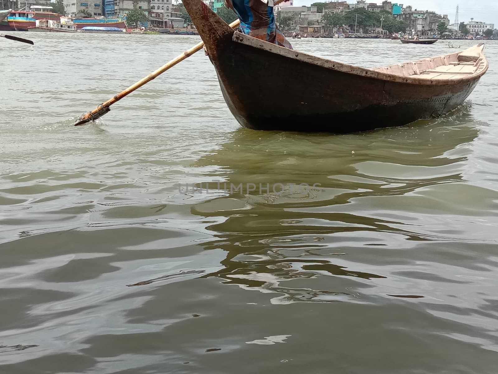 black colored wooden fishing boat on river