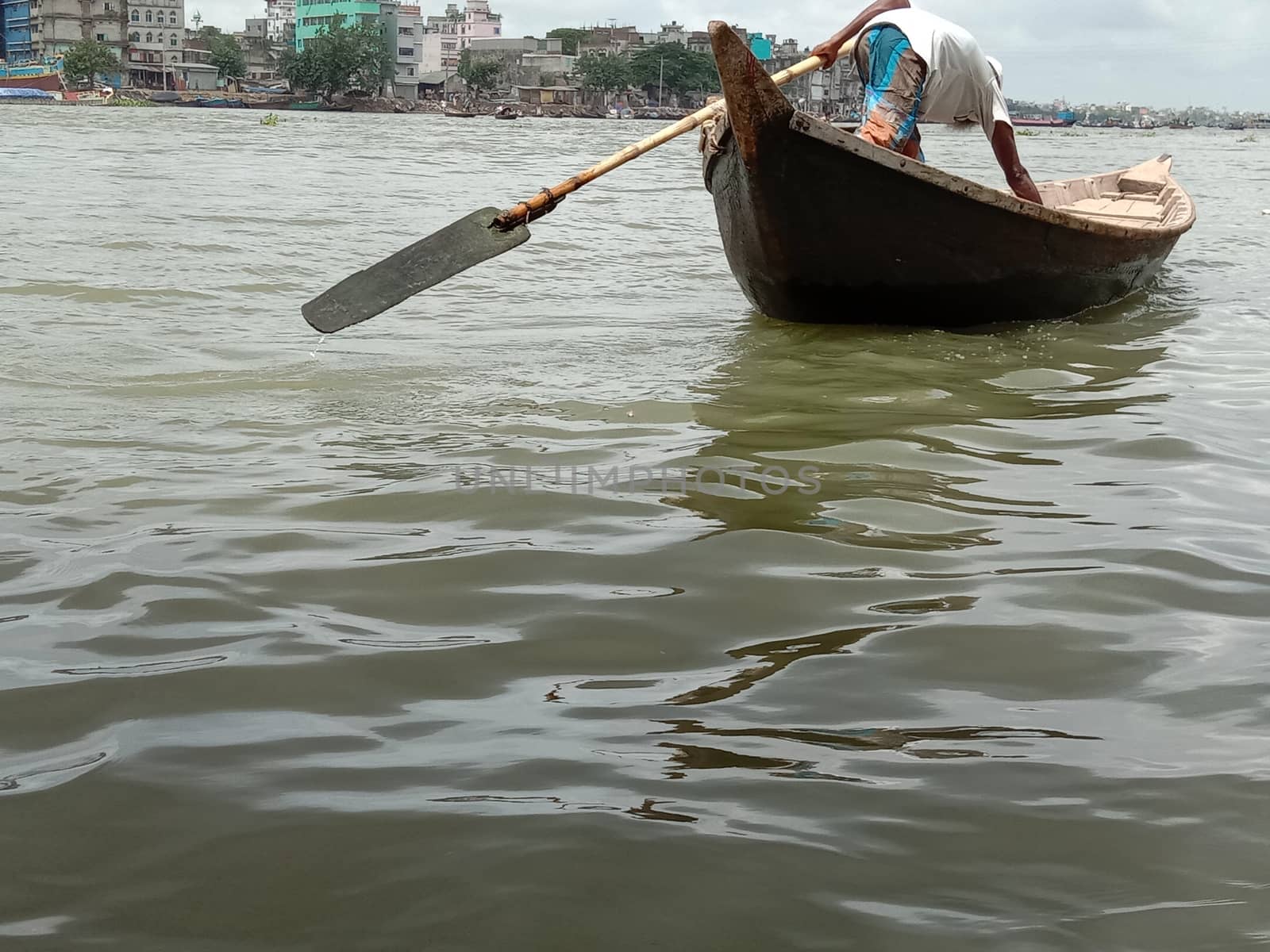 black colored wooden fishing boat on river