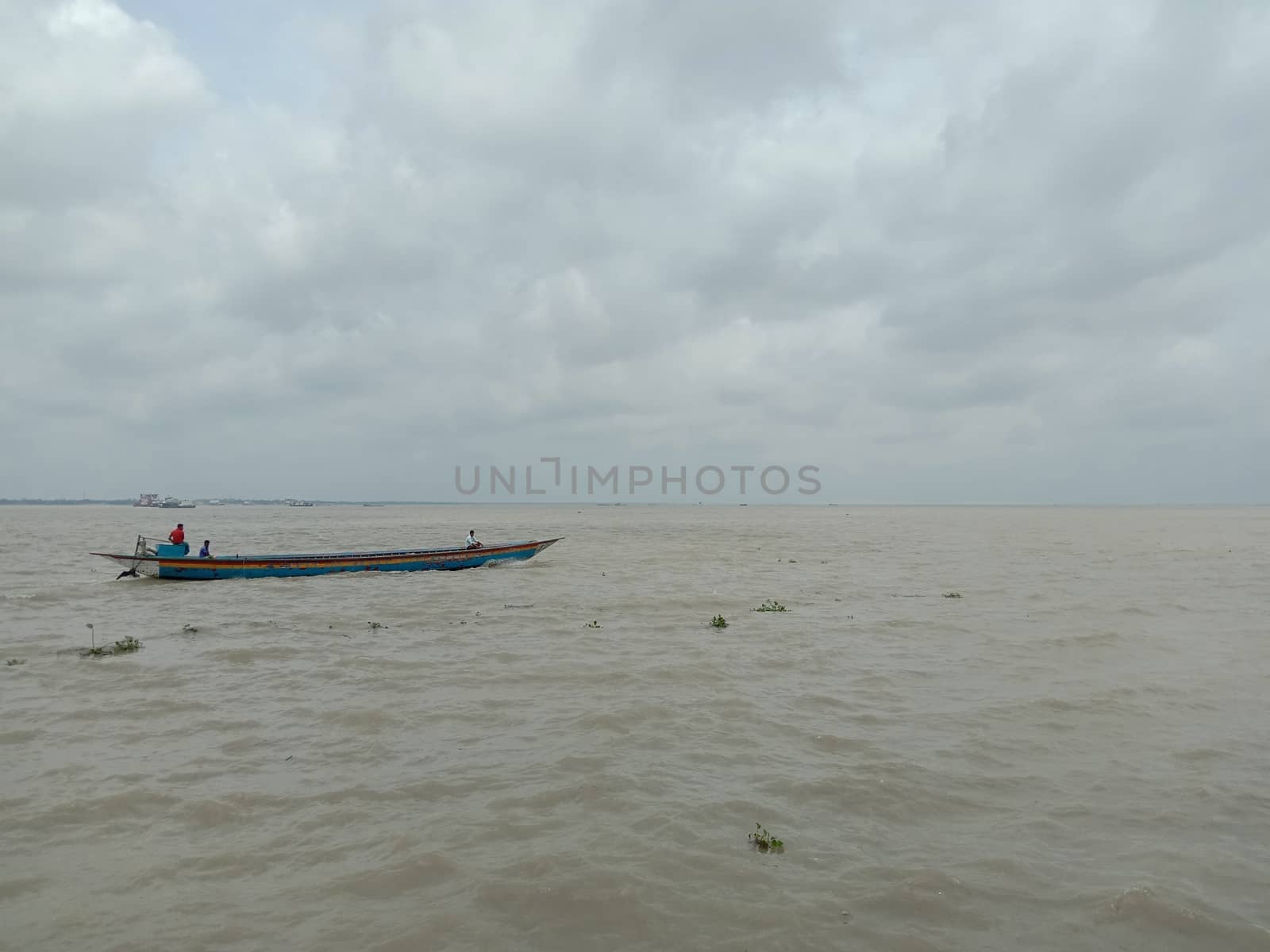 wooden fishing boat on river with sky
