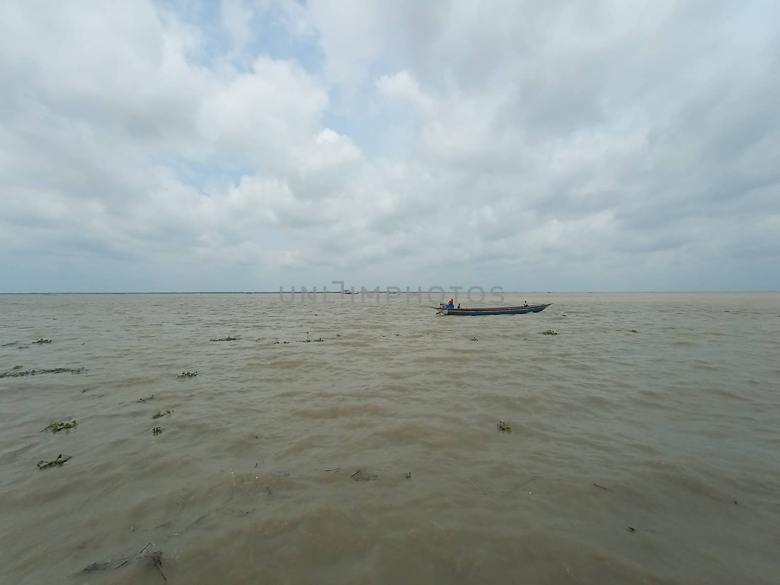 wooden fishing boat on river with sky