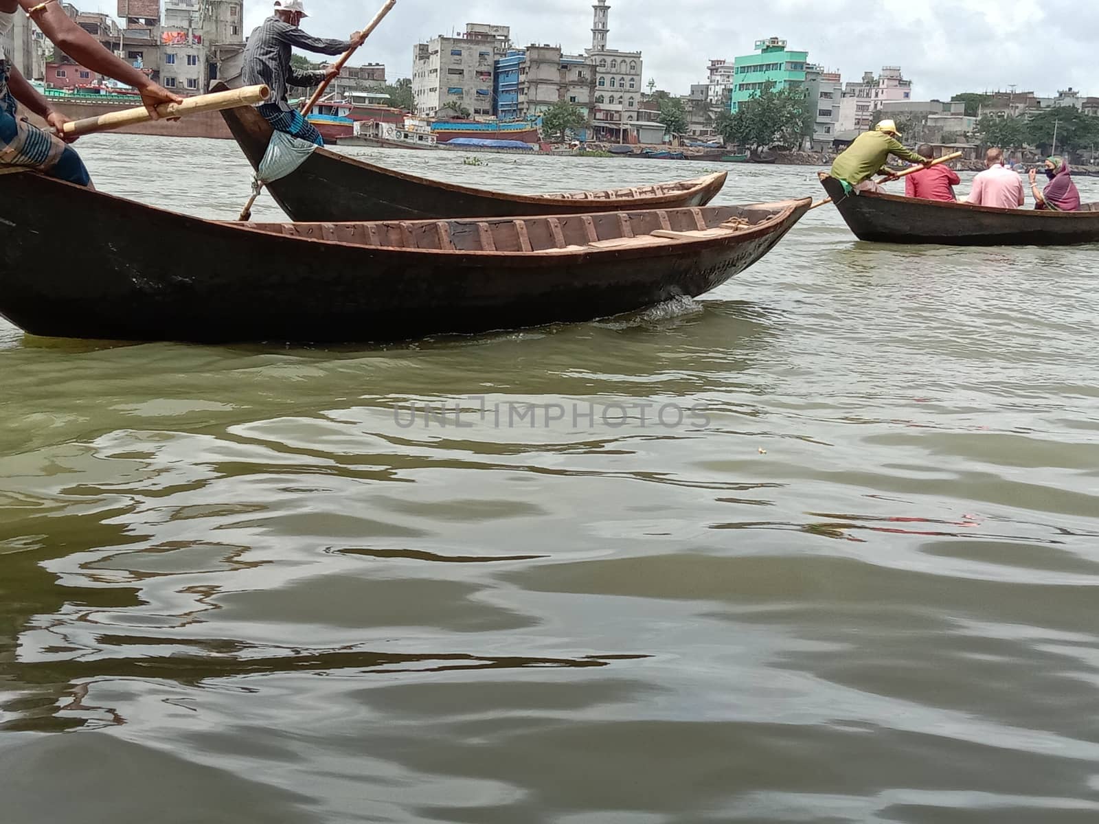 black colored wooden fishing boat on river