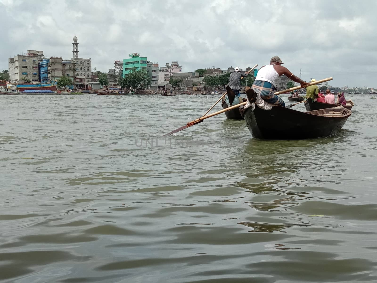 black colored wooden fishing boat on river